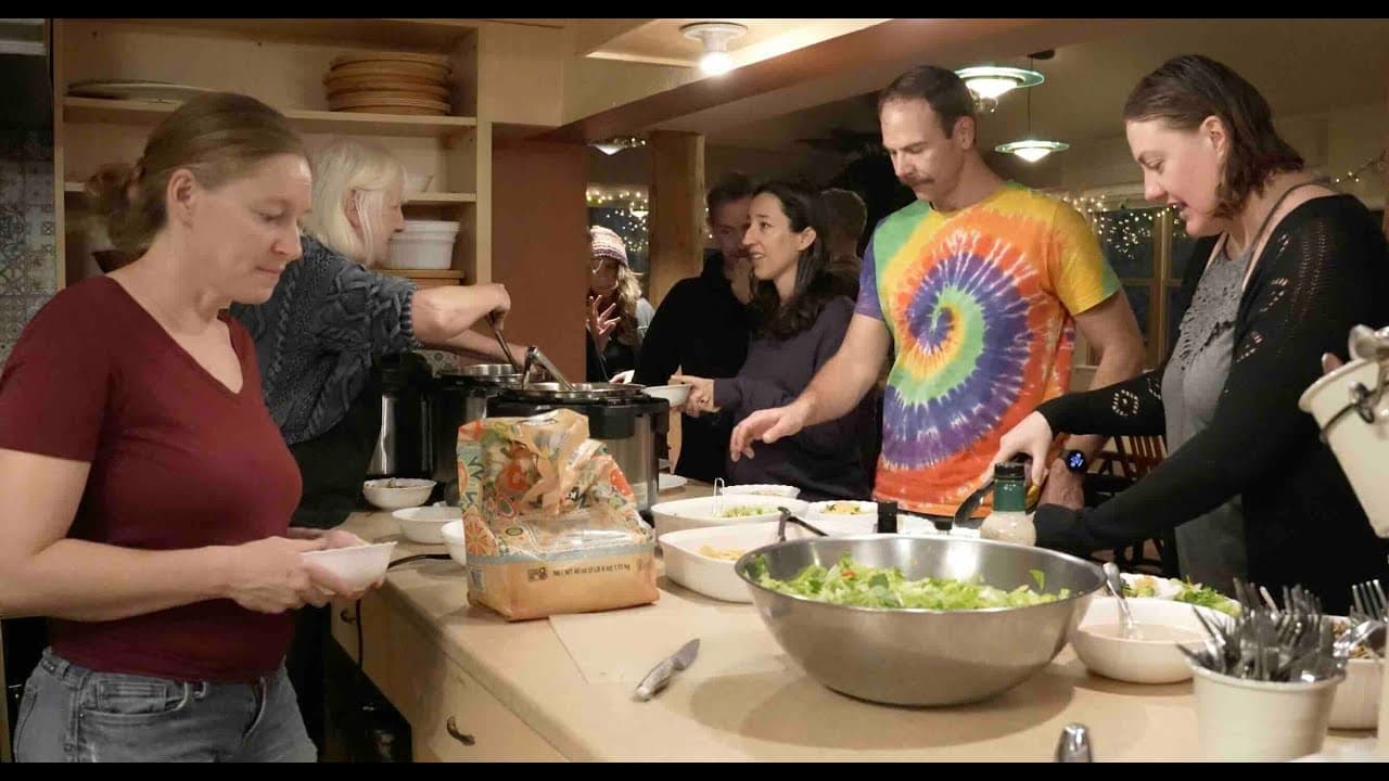 Nyland neighbors serving themselves at a shared dinner in the Common House